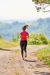 Image showing woman enjoying in a healthy lifestyle while jogging