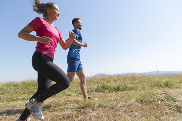 Image showing couple jogging in a healthy lifestyle on a fresh mountain air