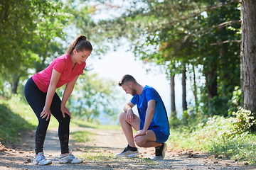 Image showing couple enjoying in a healthy lifestyle while jogging on a country road