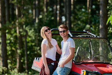 Image showing couple enjoying beautiful sunny day while driving a off road buggy