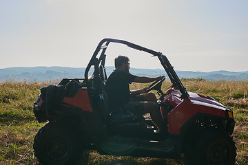 Image showing man enjoying beautiful sunny day while driving a off road buggy car