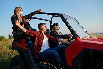 Image showing group young happy people enjoying beautiful sunny day while driving a off road buggy car