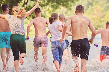 Image showing group of happy friends having fun on river