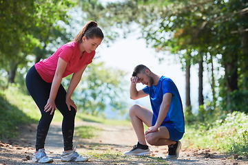 Image showing couple enjoying in a healthy lifestyle while jogging on a country road