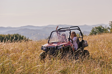 Image showing girls enjoying a beautiful sunny day while driving an off-road car