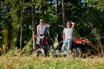 Image showing couple enjoying beautiful sunny day while driving a off road buggy