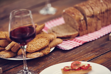 Image showing composition with a glass of red wine and toasted bread