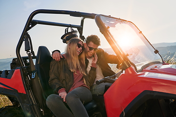 Image showing couple enjoying beautiful sunny day while driving a off road buggy