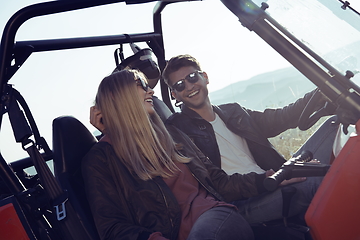 Image showing couple enjoying beautiful sunny day while driving a off road buggy