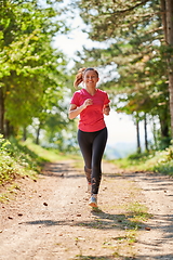 Image showing woman enjoying in a healthy lifestyle while jogging