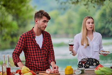 Image showing friends having picnic french dinner party outdoor during summer holiday