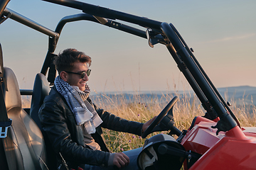 Image showing man enjoying beautiful sunny day while driving a off road buggy car