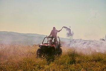 Image showing  colorful torches while driving a off road buggy car