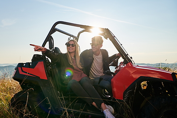 Image showing couple enjoying beautiful sunny day while driving a off road buggy