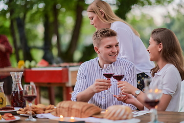 Image showing friends having picnic french dinner party outdoor during summer holiday