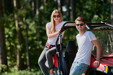 Image showing couple enjoying beautiful sunny day while driving a off road buggy