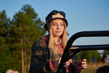 Image showing girl wearing a helmet and enjoying a buggy car ride on a mountain