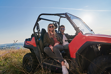 Image showing couple enjoying beautiful sunny day while driving a off road buggy