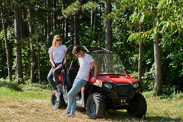 Image showing couple enjoying beautiful sunny day while driving a off road buggy