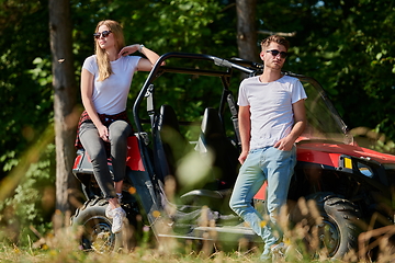 Image showing couple enjoying beautiful sunny day while driving a off road buggy