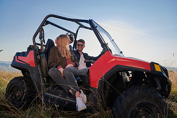 Image showing couple enjoying beautiful sunny day while driving a off road buggy