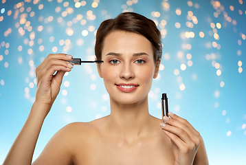 Image showing beautiful woman applying mascara
