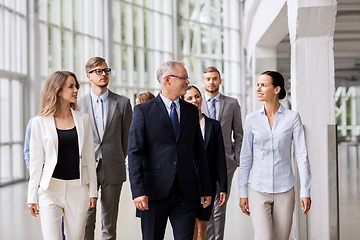 Image showing business people walking along office building