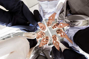 Image showing business people showing ok hand sign at office
