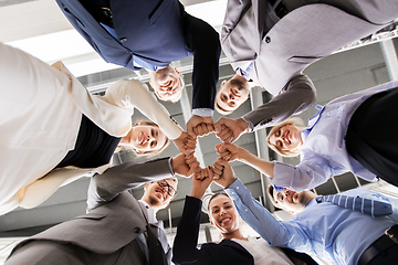 Image showing happy business people making fist bump at office