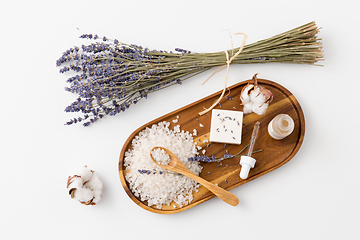 Image showing sea salt, lavender soap and serum on wooden tray