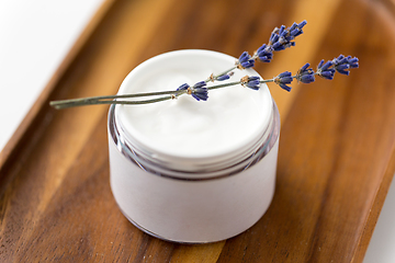 Image showing close up of lavender moisturizer on wooden tray