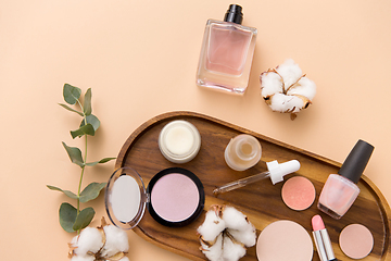 Image showing makeup, perfume and cosmetics on wooden tray