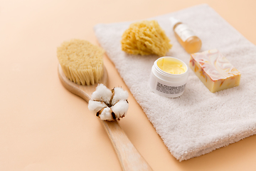 Image showing soap, brush, sponge and body butter on bath towel