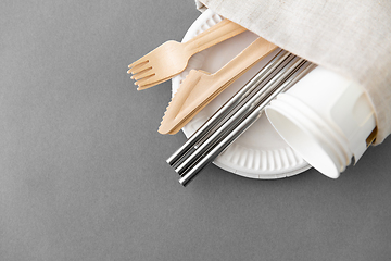 Image showing wooden forks, knives and paper cups on plate