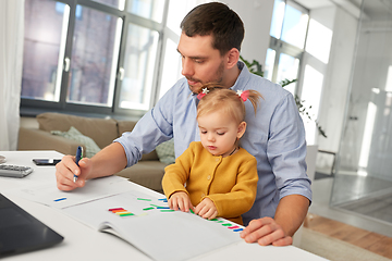 Image showing working father with baby daughter at home office