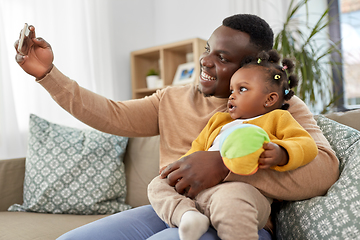 Image showing happy father with baby taking selfie at home