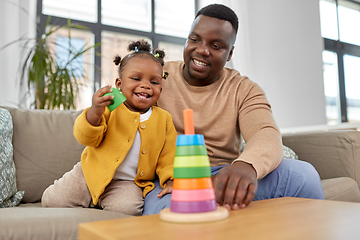 Image showing african family playing with baby daughter at home