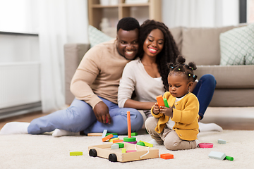 Image showing african family playing with baby daughter at home