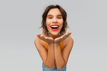 Image showing happy smiling young woman in mustard yellow top