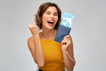 Image showing happy young woman with air ticket and passport