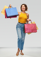 Image showing happy smiling young woman with shopping bags