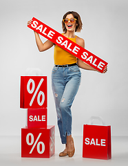 Image showing happy smiling young woman with shopping bags