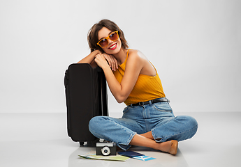 Image showing woman with travel bag, air ticket, map and camera