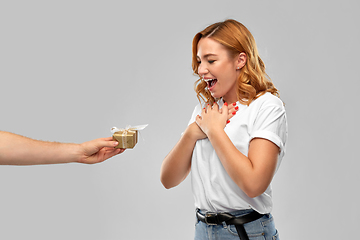 Image showing happy couple in white t-shirts with christmas gift