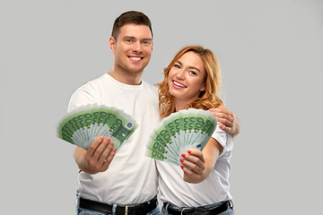 Image showing happy couple in white t-shirts with euro money