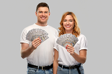 Image showing happy couple in white t-shirts with dollar money