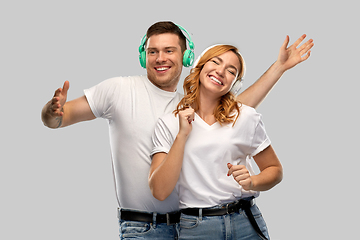 Image showing happy couple in headphones dancing