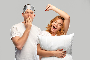 Image showing yawning couple with eye sleeping mask and pillow