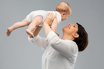 Image showing happy middle-aged mother with little baby daughter