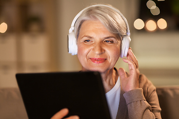 Image showing senior woman in headphones listening to music